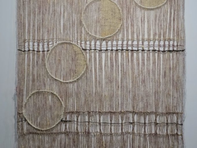 Woven artwork by fiber artist Petra Guenthner Johnson. Image of open woven pink and gray panel with images of waxing moon, woven in off-white, moving in an arc across the panel. 32x45"